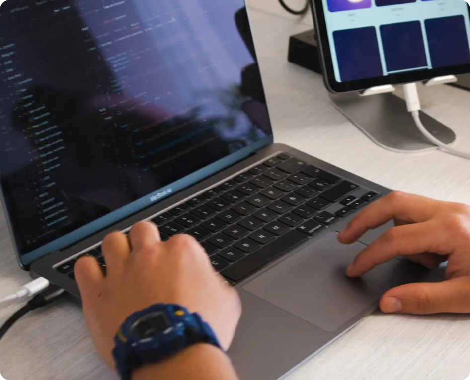 Hands typing on a Mac